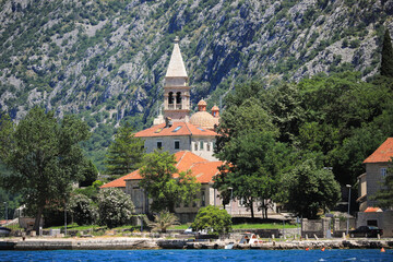 Fototapeta premium Church on the shore near the mountains in Kotor city