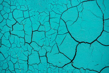 Cracked and damaged painted surface of a building or wall. Texture, aged paint background