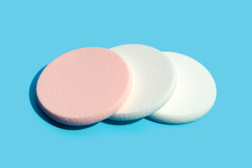 Sponge for face make-up cleaning on blue background