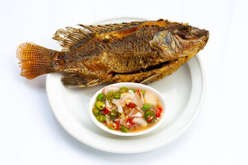 Fried fish in white plate on white background.