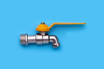 Faucet on cement on blue background