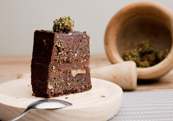 chocolate cupcake muffins with wooden grinder cannabis buds.Marijuana hemp in food dessert....