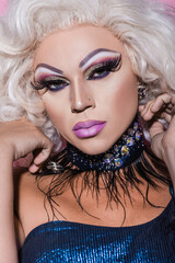 Fototapeta premium close up portrait of drag queen in glitter necklace looking at camera.
