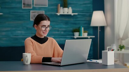 Student working on laptop at desk to create school project, doing internet research for online class assignment. Woman using computer and web technology to study educational course. - Powered by Adobe
