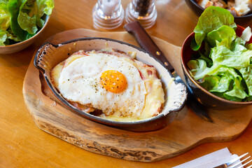 Original swiss cheese crust with fried eggs, cheese and bacon served with lettuce