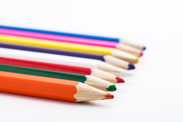 Row of colored pencils on a white background. close up. selective focus