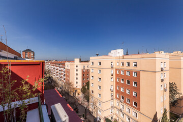 facades of residential houses and views of a street in the city of Madrid on a sunny spring day