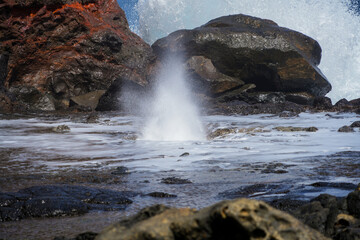 Marine geyser of Nakelele Blowhole on West Maui in the Hawaiian Islands, USA - Spout of water on volcanic rock created by the waves of the Pacific Ocean in the Poelua Bay