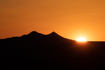 Fototapeta na wymiar Tucson Arizona mountain silhouette with sun setting behind.