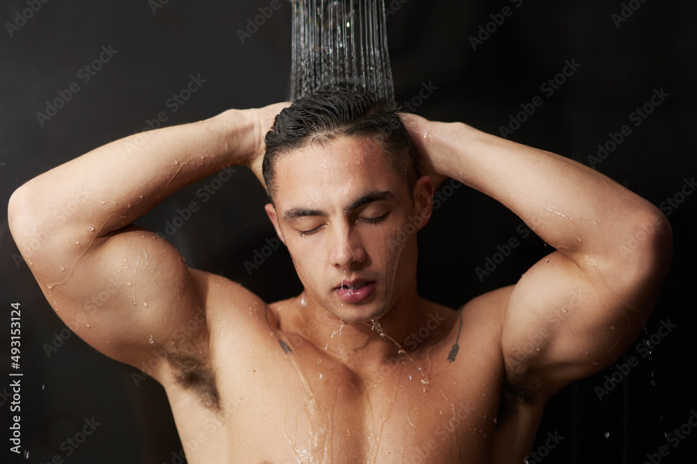 Sticker Starting his day fresh. Shot of a handsome young man having a refreshing shower at home.