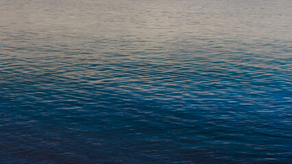 Blue ripples in a water surface on a lake.