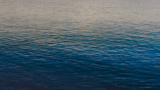 Blue ripples in a water surface on a lake.
