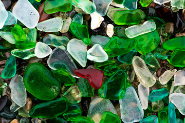 Glass Bay in Vladivostok. Sea-polished colored glass on the beach. Background, texture