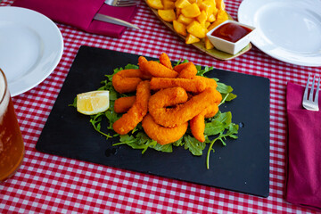 Sepia breaded and fried closeup (chocos, typical tapa in Spain)