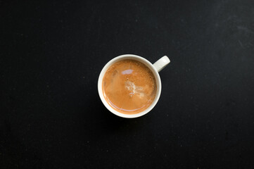 Obraz na płótnie Canvas cup of coffee on black table in cafe