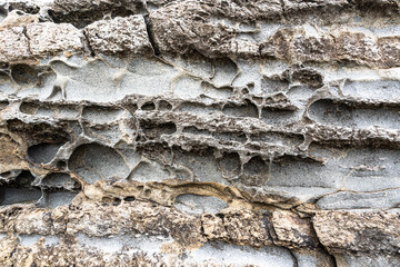 texture of porous stones on the beach, nature, natural phenomena, brown gray stones