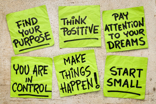 find your purpose, think positive, start small and other motivational phrases - a set of crumpled reminder notes against grunge barn wood
