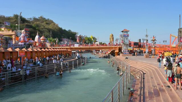 Haridwar, Uttarakhand, India - 10th April 2021 : Hindu devotees bathing in Holy river Ganges, on the occassion of Kumbh Mela. Ritual is called shahi snan, shaahi snan or Kumbh snan. 4k video.