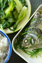 top view fast food of steamed fish and vegetable and rice at vertical composition