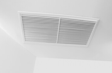 Air conditioning ventilation duct.  Air vent grid on white ceiling. Cooling temperature in the room. Home appliance. Fresh air flow.