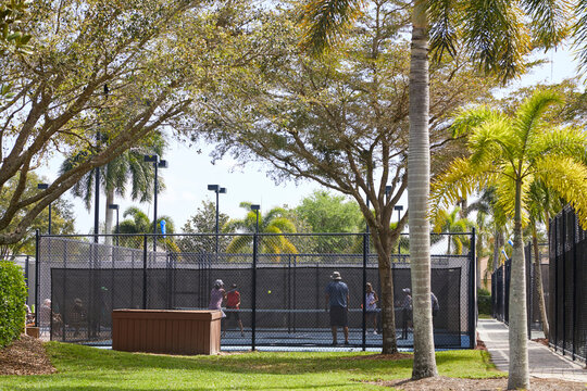 Seniors Playing Pickleball In A Beautiful Outdoor Setting In The Southern United States