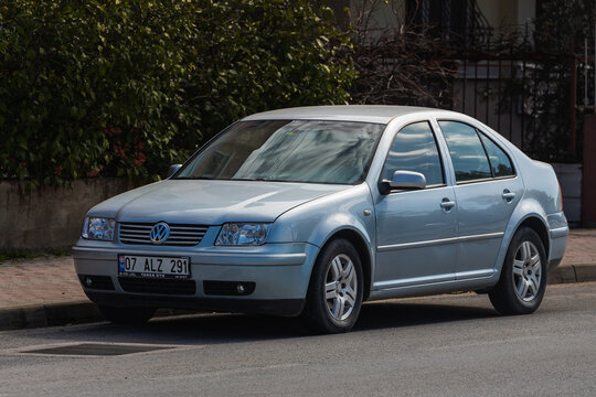 Side; Turkey &ndash; March 01 2022:  silver Volkswagen Bora   is parked  on the street on a warm  day against the backdrop of a buildung, trees, fence