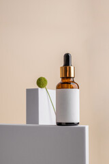 Mock-up concept with a glass-brown serum with a skin care pipette and a pad for an inscription on a background of geometric shapes. Health and beauty concept