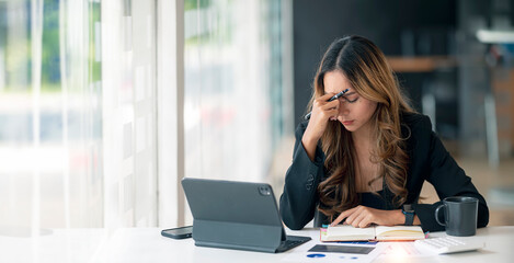 Stressed business woman working at office on laptop closed her eyes, looking worried, tired and overwhelmed.