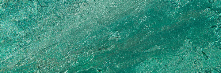 abstract background: textured plaster with emerald turquoise color, close