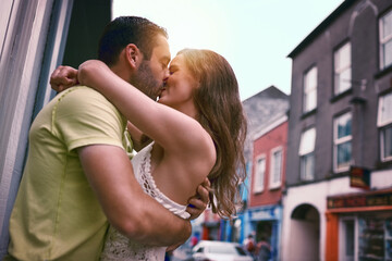 Love is an adventure of a lifetime. Shot of an affectionate young couple kissing while exploring a foreign city.