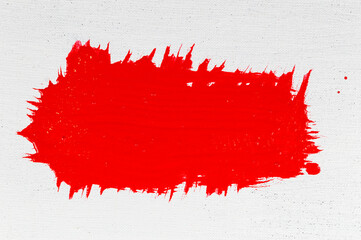 thick red acrylic paint applied in an uneven patch on a flat surface
