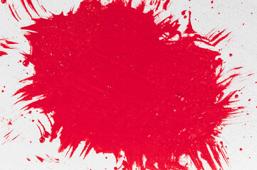 thick red acrylic paint applied in an uneven patch on a flat surface