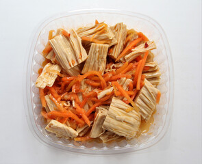 Asparagus salad with carrots. Salad in a disposable bowl.