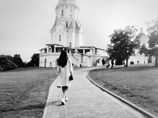 a pedestrian walking on the roadway near the church of the Ascension In Kolomenskoye, Moscow, Russia