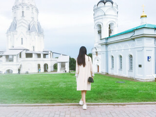 a pedestrian walking on the roadway near the church of the Ascension In Kolomenskoye, Moscow, Russia