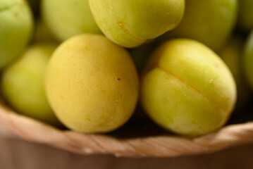 Apricot green with yellow (Japanese apricot) in basket, Close up