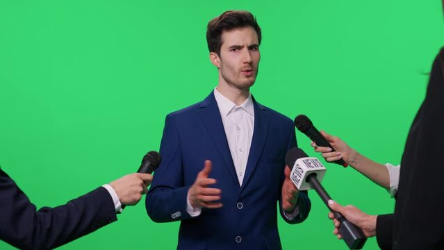 Meeting with the press, an man in a suit gives an interview to journalists, young businessman talks to the press, chromakey template.