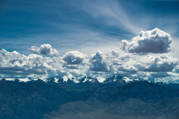 clouds over the snow covered mountains