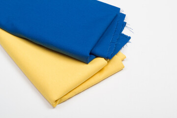 Rolls of bright colored fabric on a white background.