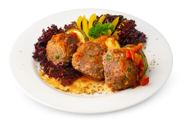 Meat balls with vegetables on white plate isolated on white
