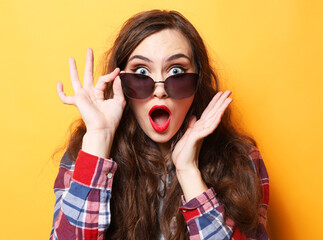 Young surprised woman wearing casual over yellow background