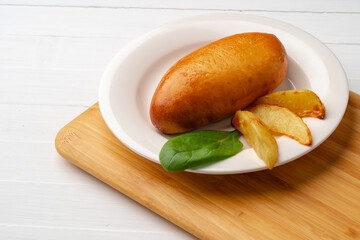Traditional Russian pie or patty on white plate