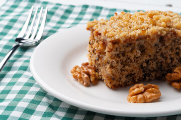 Piece of nut cake on white plate