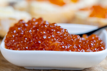 red salmon or trout caviar with white baguette and butter