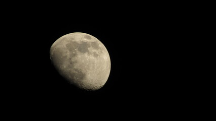 The moon in the night sky. Black lunar background. Wallpaper with the moon.