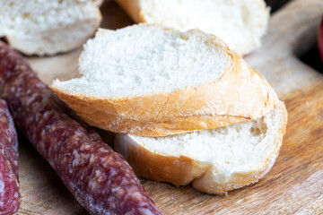 sliced pieces of sausage from meat are lying on a cutting board