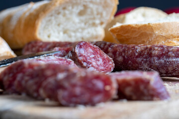 sliced pieces of sausage from meat are lying on a cutting board