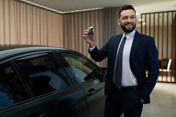 businessman businessman man in a stylish business suit bought a new car in a car dealership