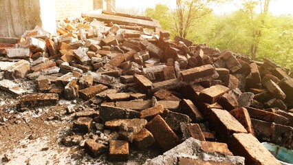 Close-up of the rubble of an industrial building collapsing into a pile of concrete and brick. and the jagged debris caused by the failure of the engineers at the abandoned construction.