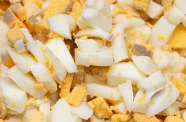 Sliced boiled eggs as a background.